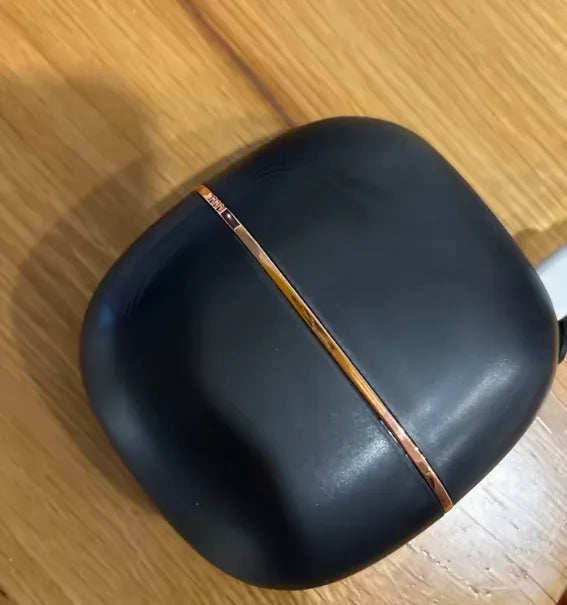 Liora compact hair brush closed on wooden surface - real product photo